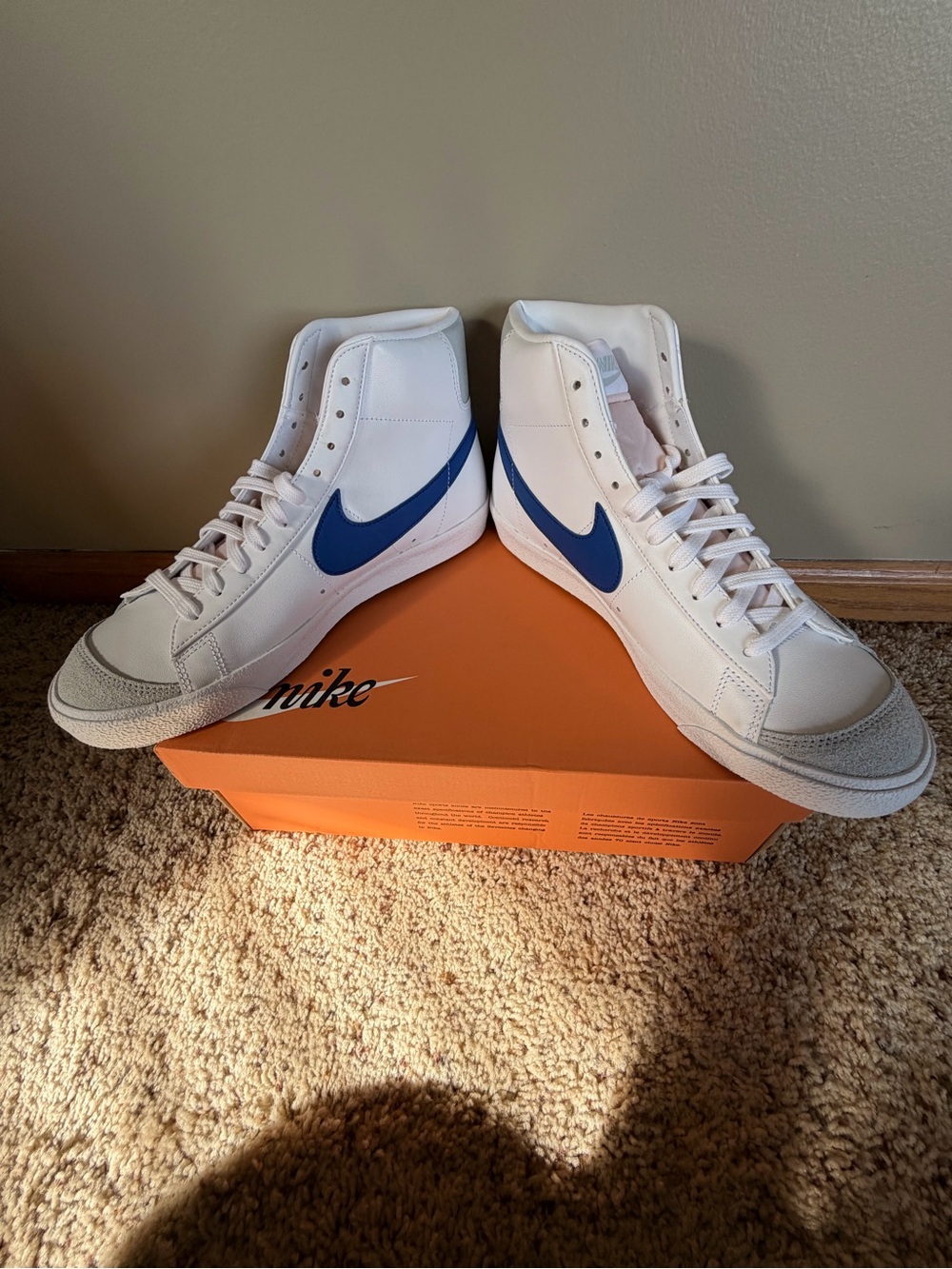 Nike Men’s White High-Top Sneakers with Blue Swoosh Accents